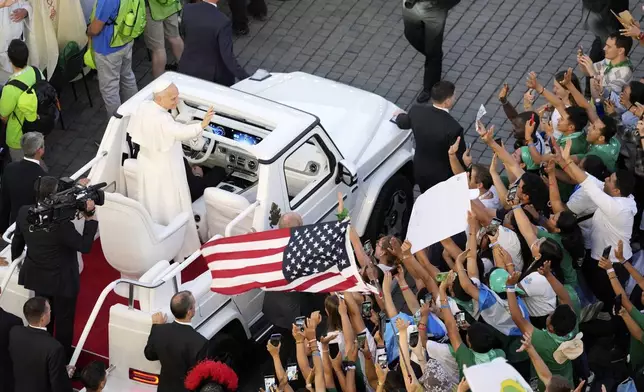 Pope Leo XIV greets faithful in St. Peter's Square at the end of a welcome mass for the Youth Jubilee at the Vatican, Tuesday, July 29, 2025. (AP Photo/Gregorio Borgia)