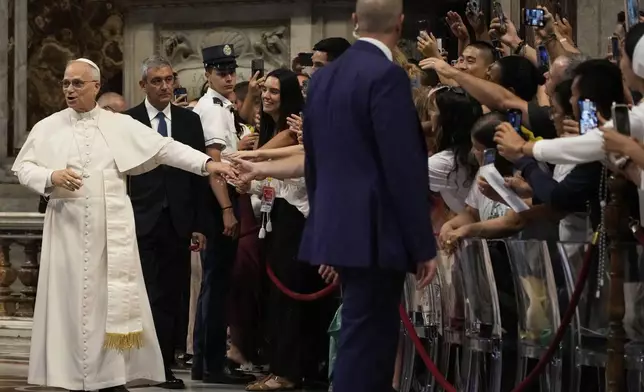 Pope Leo XIV greets faithful at the end of a mass celebrated by Cardinal Luis Antonio Tagle in St. Peter's Basilica on the occasion of the Youth Jubilee at the Vatican, Tuesday, July 29, 2025. (AP Photo/Gregorio Borgia)