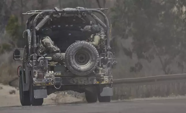 Israeli soldiers drive near the border with the Gaza Strip, in southern Israel, Wednesday, July 2, 2025. (AP Photo/Ohad Zwigenberg)