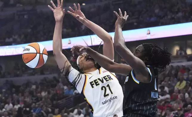 Chicago Sky center Elizabeth Williams, right, blocks a shot by Indiana Fever forward Makayla Timpson, left, during the first half of a WNBA basketball game Sunday, July 27, 2025, in Chicago. (AP Photo/Nam Y. Huh)