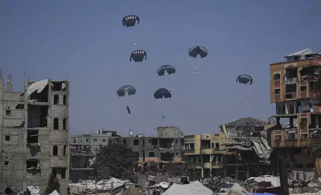 Humanitarian aid is airdropped to Palestinians over northern Gaza Strip, Sunday, July 27, 2025. (AP Photo/Abdel Kareem Hana)