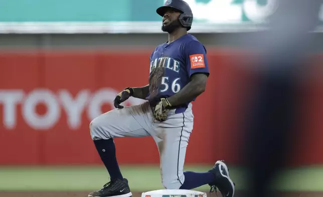 Seattle Mariners' Randy Arozarena kneels after stealing second base during the fourth inning of a baseball game against the Athletics Tuesday, July 29, 2025, in West Sacramento, Calif. (AP Photo/Sergio Estrada)