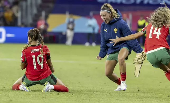 Portugal's Diana Gomes, left, celebrates after scoring her side's first goal during the Euro 2025 group B soccer match between Portugal and Italy at Stade de Geneve in Geneva, Switzerland, Monday, July 7, 2025. (Salvatore Di Nolfi/Keystone via AP)
