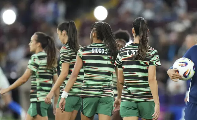 Portugal players wear shirts with the name of Portugal international and Liverpool player Diogo Jota who died recently, during warmup before the Euro 2025, group B, soccer match between Portugal and Italy at Stade de Geneve in Geneva, Switzerland, Monday, July 7, 2025. (AP Photo/Alessandra Tarantino)