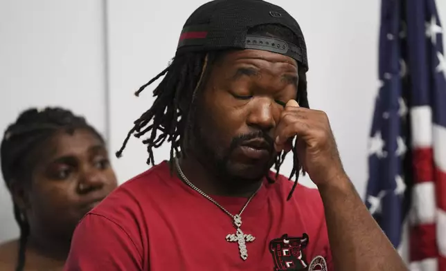One of sexual assault survivor Michael Moss wipes his eyes as he listens to Jerome Block, partner, Levy &amp; Konigsberg LLP, during a news conference in Chicago, Wednesday, July 16, 2025. (AP Photo/Nam Y. Huh)