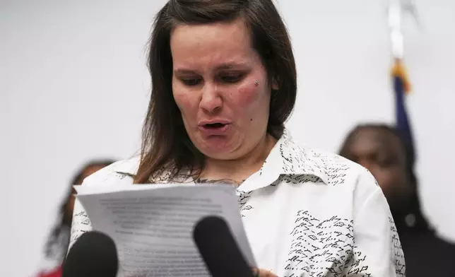 One of sexual assault survivor Kate-Lynn (first name only), cries as she talks to media during a news conference in Chicago, Wednesday, July 16, 2025. (AP Photo/Nam Y. Huh)