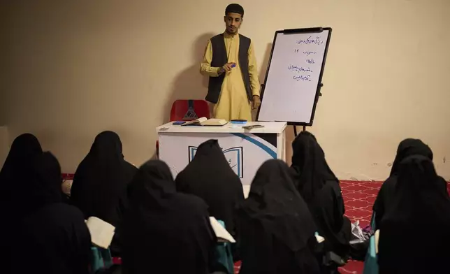 A teacher gives a religious studies lesson to girls at a religious education center in Kabul, Afghanistan, Wednesday, May 28, 2025. (AP Photo/Ebrahim Noroozi)