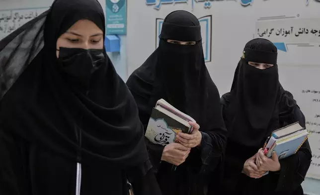 Afghan girls walk through the courtyard of a religious education center in Kabul, Afghanistan, Wednesday, May 28, 2025. (AP Photo/Ebrahim Noroozi)