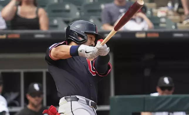 Cleveland Guardians' Steven Kwan hits a sacrifice fly during the 10th inning of a baseball game against the Chicago White Sox in Chicago, Sunday, July 13, 2025. (AP Photo/Nam Y. Huh)