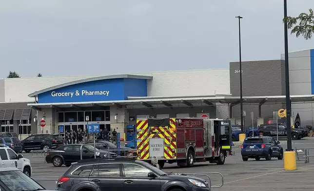 Emergency services respond after multiple people were stabbed at a Walmart in Traverse City, Mich., Saturday, July 26, 2025. (Jan-Michael Stump/Traverse City Record-Eagle via AP)