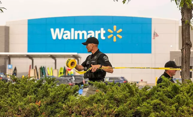 Grand Traverse Sheriff's deputies tape off the parking lot of a Walmart after a stabbing incident in Traverse City, Mich., Saturday July 26, 2025. (Jan-Michael Stump/Traverse City Record-Eagle via AP)