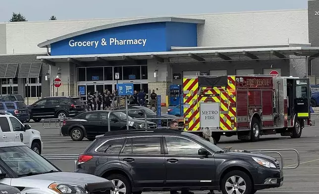 Emergency services respond after multiple people were stabbed at Walmart in Traverse City, Mich., Saturday, July 26, 2025. (Jan-Michael Stump/Traverse City Record-Eagle via AP)