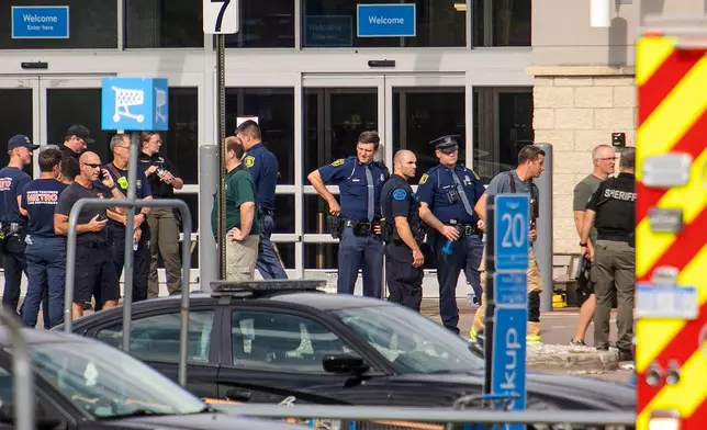 Members of the law enforcement in the area work the scene after a stabbing incident at a Walmart in Traverse City, Mich., Saturday July 26, 2025. (Jan-Michael Stump/Traverse City Record-Eagle via AP)