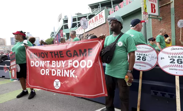 Concession workers from Fenway Park picket outside the ballpark Friday, July 25, 2025, in Boston before a baseball game between the Boston Red Sox and the Los Angeles Dodgers. (AP Photo/Mark Stockwell)