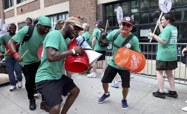 Concession workers from Fenway Park picket outside the ballpark Friday, July 25, 2025, in Boston before a baseball game between the Boston Red Sox and the Los Angeles Dodgers. (AP Photo/Mark Stockwell)