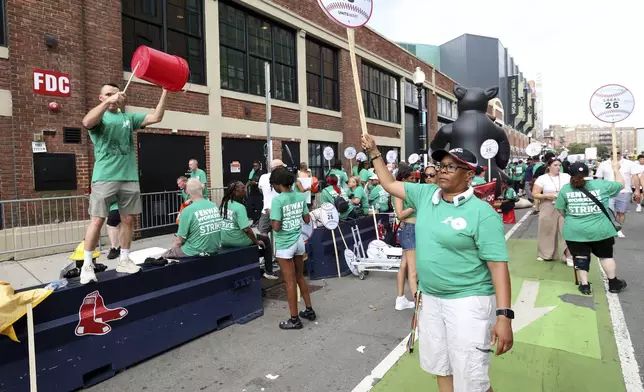 Concession workers from Fenway Park picket outside the ballpark Friday, July 25, 2025, in Boston before a baseball game between the Boston Red Sox and the Los Angeles Dodgers. (AP Photo/Mark Stockwell)