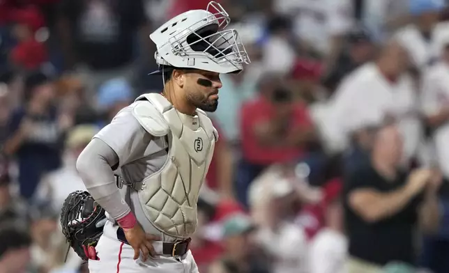 Boston Red Sox catcher Carlos Narváez waits for umpires to call catcher's interference on him during an at-bat by Philadelphia Phillies' Edmundo Sosa with the bases loaded during the 10th inning of a baseball game Monday, July 21, 2025, in Philadelphia. (AP Photo/Matt Slocum)