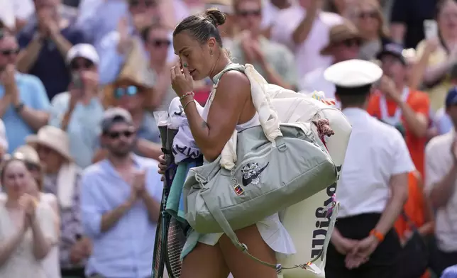 Aryna Sabalenka of Belarus leaves the court after losing to Amanda Anisimova of the U.S. during a women's singles semifinal match at the Wimbledon Tennis Championships in London, Thursday, July 10, 2025. (AP Photo/Kirsty Wigglesworth)