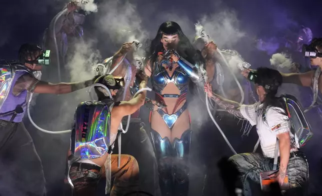 Katy Perry, center, performs with dancers as part of the "Lifetimes Tour" on Tuesday, July 15, 2025, at Kia Forum in Inglewood, Calif. (AP Photo/Chris Pizzello)
