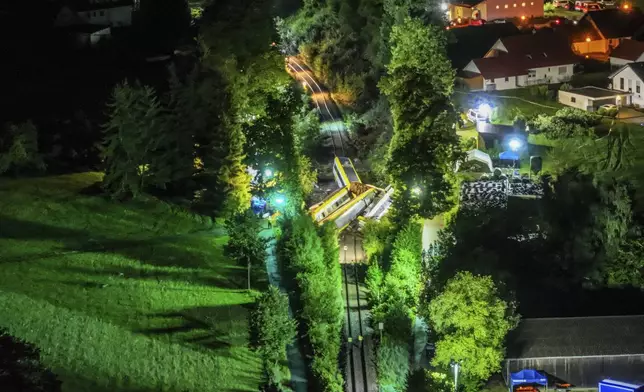 Wagons of a derailed regional passenger train lie on a railroad line near Riedlingen, Germany, early Monday, July 28, 2025. (Dpa via AP)