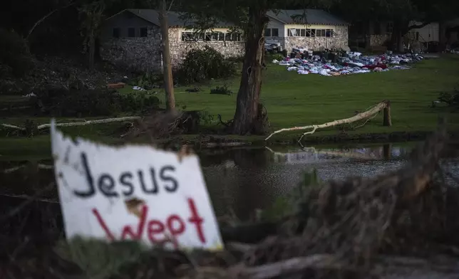 FILE - Camper's belongings sit outside one of Camp Mystic's cabins near the Guadalupe River after a flash flood swept through the area Monday, July 7, 2025, in Hunt, Texas. (AP Photo/Eli Hartman, File)