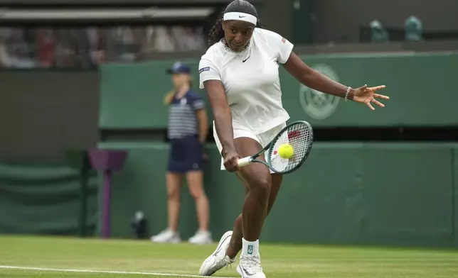 Hailey Baptiste of the U.S. serves to Mirra Andreeva of Russia during their women's singles third round match at the Wimbledon Tennis Championships in London, Saturday, July 5, 2025.(AP Photo/Alastair Grant)