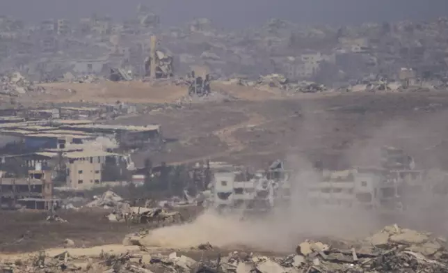 Israeli soldiers drive on their armored personnel carrier inside the northern Gaza Strip, as seen from southern Israel, Tuesday, July 29, 2025. (AP Photo/Ariel Schalit)