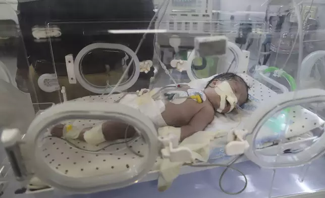 Newborn Soad Qeshtah seen in an incubator in Nasser Hospital in Khan Younis, hours before she died. Her mother, who was seven months pregnant, was killed in an Israeli airstrike in the Gaza Strip and the baby was delivered by emergency cesarean section, Monday, July 28, 2025. (AP Photo/Mariam Dagga)