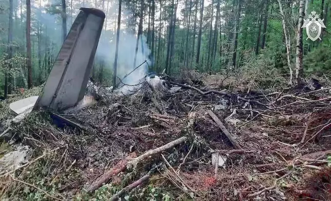 In this photo taken from video released by Russian Investigative Committee on Thursday, July 24, 2025, a view of the place of the crashed Russian An-24 passenger plane of the Siberia-based Angara Airlines while carrying 49 passengers in 15 kilometers (9 miles) south of Tynda, Far Eastern Amur region of Russia. (Russian Investigative Committee via AP)