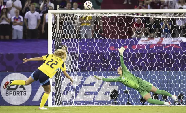 Sweden's Smilla Holmberg, left, misses her shot high against England's goalkeeper Hannah Hamptonin during the penalty shootout the Women's Euro 2025 quarterfinals soccer match between Sweden and England at Stadion Letzigrund in Zurich, Switzerland, Thursday, July 17, 2025. (Michael Buholzer/Keystone via AP)