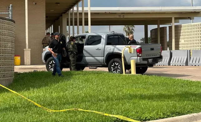 Officials work the scene of a shooting at a Border Patrol facility in McAllen, Texas, Monday, July 7, 2025. (AP Photo/Valerie Gonzalez)