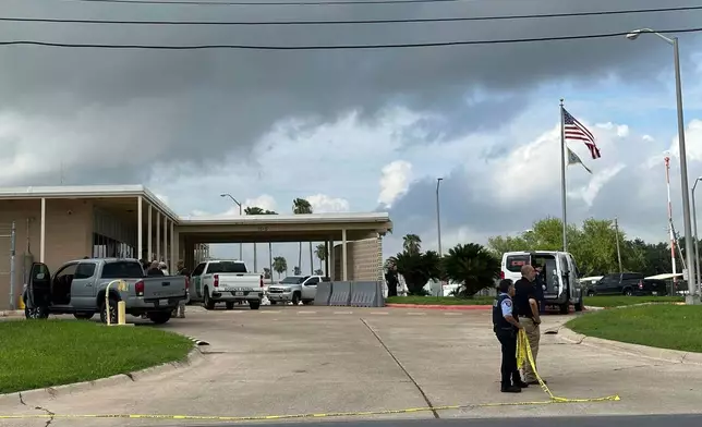 Officials work the scene of a shooting at a Border Patrol facility in McAllen, Texas, Monday, July 7, 2025. (AP Photo/Valerie Gonzalez)