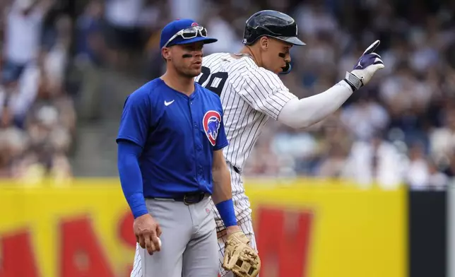 New York Yankees' Aaron Judge (99) reacts after hitting a double during the fourth inning of a baseball game against the Chicago Cubs, Saturday, July 12, 2025, in New York. (AP Photo/Yuki Iwamura)