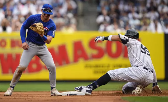 New York Yankees' Aaron Judge (99) slides into second base for a double during the fourth inning of a baseball game against the Chicago Cubs, Saturday, July 12, 2025, in New York. (AP Photo/Yuki Iwamura)