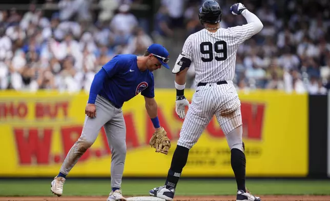 New York Yankees' Aaron Judge (99) reacts after hitting a double during the fourth inning of a baseball game against the Chicago Cubs, Saturday, July 12, 2025, in New York. (AP Photo/Yuki Iwamura)