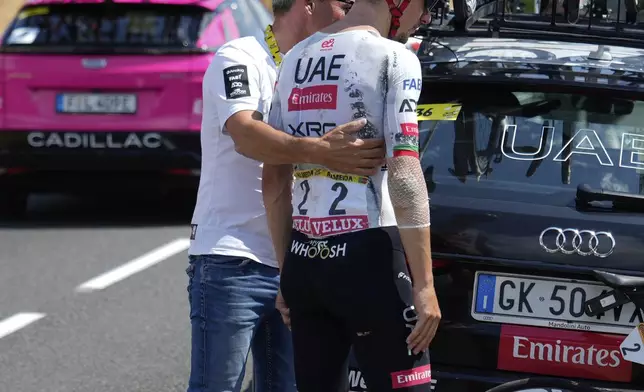 Portugal's Joao Almeida retires from the race during the ninth stage of the Tour de France cycling race over 174.1 kilometers (108 miles) with start in Chinon and finish in Chateauroux, France, Sunday, July 13, 2025. (AP Photo/Mosa'ab Elshamy)