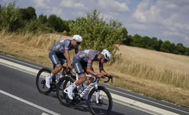 Netherlands' Mathieu van der Poel, right, and teammate Belgium's Jonas Rickaert, left, ride breakaway during the ninth stage of the Tour de France cycling race over 174.1 kilometers (108 miles) with start in Chinon and finish in Chateauroux, France, Sunday, July 13, 2025. (AP Photo/Mosa'ab Elshamy)