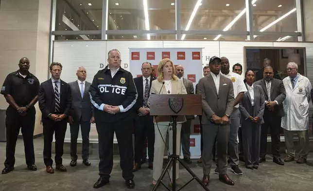 Flanked by New York Mayor Eric Adams, right, and NYPD Chief of Department John Chell, left, New York Police Commissioner Jessica Tisch speaks during a news conference at New York Presbyterian Weil Cornell Medical Center where a police officer was brought after being shot at a Manhattan office building, Monday, July 28, 2025, in New York. (AP Photo/Angelina Katsanis)