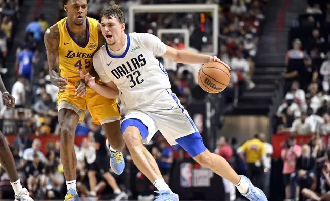 Dallas Mavericks forward Cooper Flagg (32) drives the ball against Los Angeles Lakers guard DaJaun Gordon (45) during the second half of an NBA summer league basketball game Thursday, July 10, 2025, in Las Vegas. (AP Photo/David Becker)
