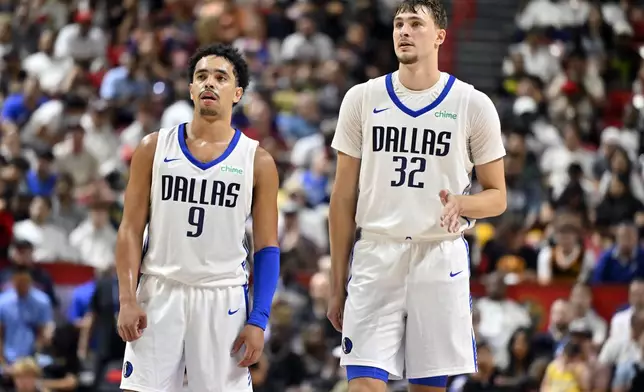 Dallas Mavericks guard Ryan Nembhard (9) and forward Cooper Flagg (32) look on during the second half of an NBA summer league basketball game against the Los Angeles Lakers, Thursday, July 10, 2025, in Las Vegas. (AP Photo/David Becker)