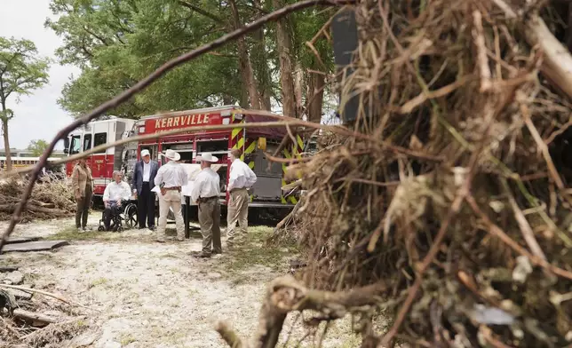 First lady Melania Trump, from left, Texas Gov. Greg Abbott and President Donald Trump are briefed on flood damage in Kerrville, Texas, Friday, July 11, 2025. (AP Photo/Jacquelyn Martin)