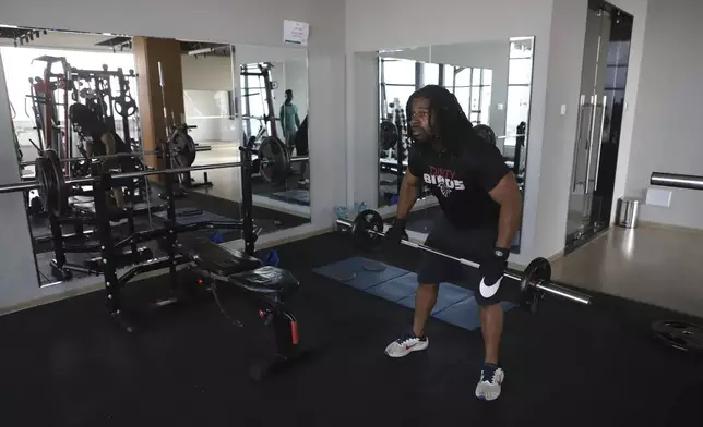 Kenneth Harris, a 38-year-old retired veteran, lifts weights at a gym in Nairobi, Kenya, Friday, May 23, 2025. (AP Photo/Andrew Kasuku)