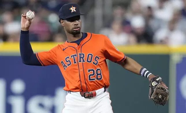 Houston Astros second baseman Brice Matthews (28) throws to first base for an out during the first inning of a baseball game against the Texas Rangers, Friday, July 11, 2025, in Houston. (AP Photo/Kevin M. Cox)