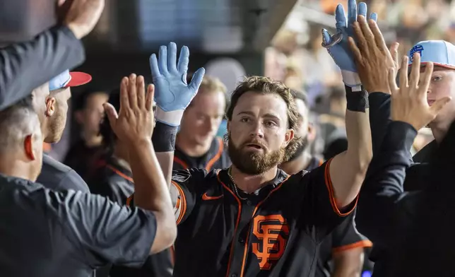 San Francisco Giants' Brett Wisely celebrates in the dugout after hitting a solo home run during the eighth inning of a baseball game against the Athletics Friday, July 4, 2025, in West Sacramento, Calif. (AP Photo/Sara Nevis)