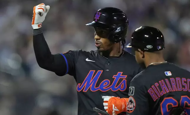 New York Mets' Francisco Lindor gestures to teammates after hitting an RBI single during the sixth inning in the second baseball game against the Milwaukee Brewers of a doubleheader Wednesday, July 2, 2025, in New York. (AP Photo/Frank Franklin II)