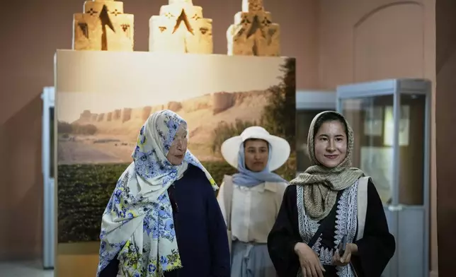 Afghan tour guide Somaya Moniry, 24, right, and Maryam, a local trainee tour guide, center, accompany 82-year-old Australian tourist Suzanne Sandral, left, during a visit to the National Museum in Kabul, Afghanistan, Wednesday, May 28, 2025. (AP Photo/Ebrahim Noroozi)