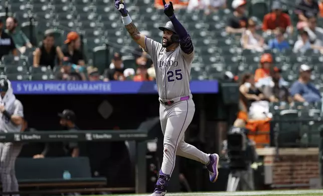 Colorado Rockies' Warming Bernabel gestures as he runs toward home plate after hitting a home run off Baltimore Orioles pitcher Tomoyuki Sugano during the second inning of a baseball game in Baltimore, Sunday, July 27, 2025. (AP Photo/Terrance Williams)
