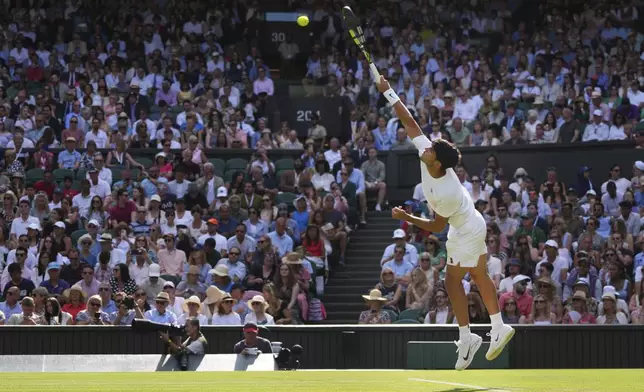 Carlos Alcaraz of Spain serves the ball to Oliver Tarvet of Britain in his second round men's singles match at the Wimbledon Tennis Championships in London, Wednesday, July 2, 2025.(AP Photo/Kirsty Wigglesworth)