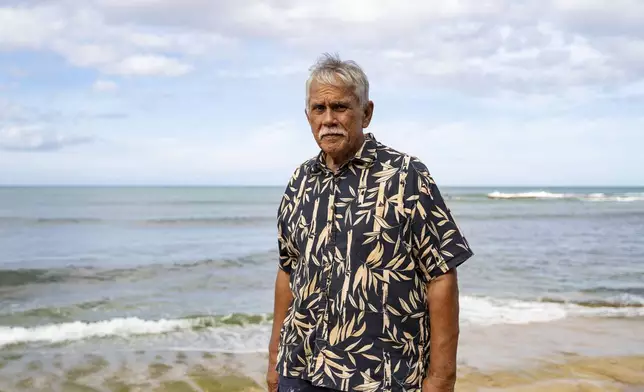 Cultural practitioner Glen Kila poses for a portrait near the shoreline where ancient petroglyphs at Pokai Bay, July 22, 2025, in Waianae, Hawaii. (AP Photo/Mengshin Lin)