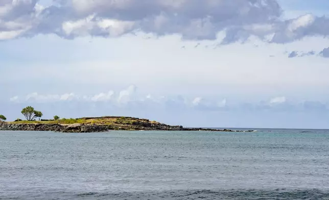 A view of Kaneʻilio, a temple near Pokai Bay that cultural practitioner Glen Kila believes is spiritually connected to the nearby petroglyphs carved into the rock along the shoreline, July 22, 2025, in Waianae, Hawaii. (AP Photo/Mengshin Lin)